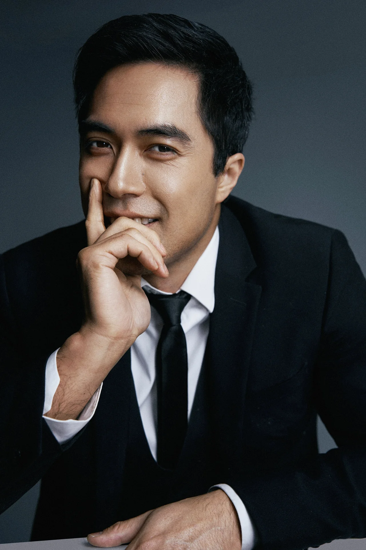 Damien Sato in a tailored suit